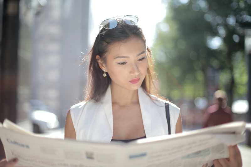 Woman reading newspaper